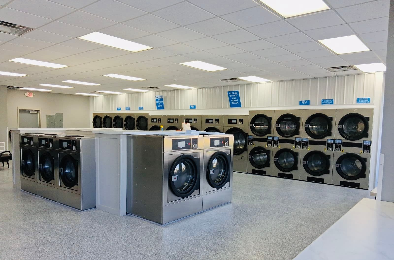 Rows of commercial washers and dryers
